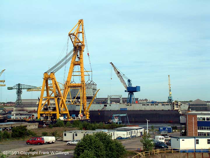 Asian Hercules II and the Royal Fleet Auxiliary Landing ship vessel Largs Bay on the river Tyne UK in the process of a heavy lift.