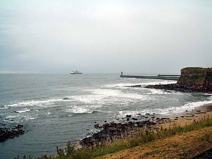 Distance view of the Queen Mary 2 passing the Tynemouth light house on her way to Edinburgh. 12 july 2004